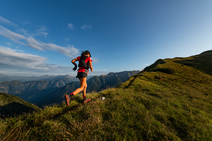Sporty mountain woman rides in trail during endurance trail Sporty mountain woman rides in trail during endurance trail